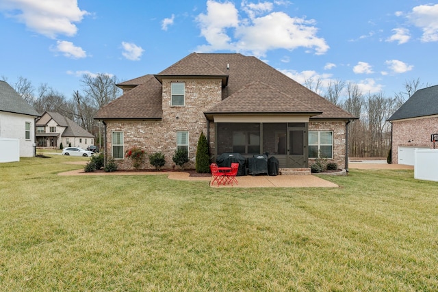 back of house featuring a sunroom, a yard, and a patio area