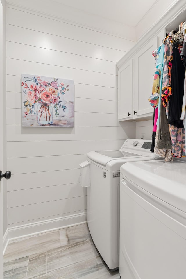 laundry room featuring cabinets and washing machine and clothes dryer