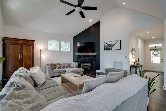 living room with high vaulted ceiling, a fireplace, hardwood / wood-style floors, and a wealth of natural light