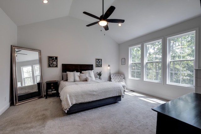 bedroom with vaulted ceiling, light colored carpet, and ceiling fan