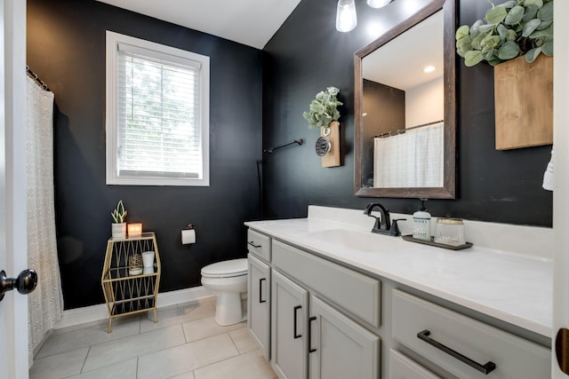 bathroom with vanity, toilet, and tile patterned flooring