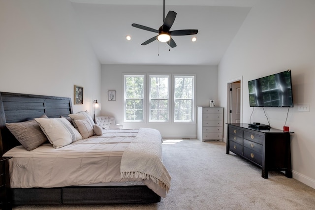 bedroom with ceiling fan, light colored carpet, and high vaulted ceiling