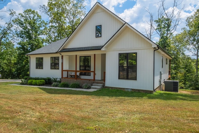 modern inspired farmhouse with central AC, covered porch, and a front yard