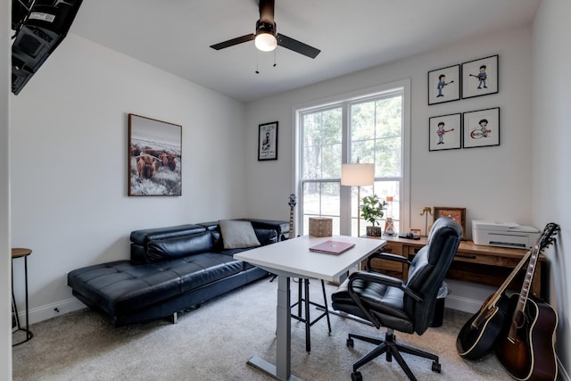 carpeted office space with ceiling fan