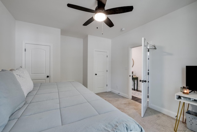 bedroom featuring light colored carpet and ceiling fan