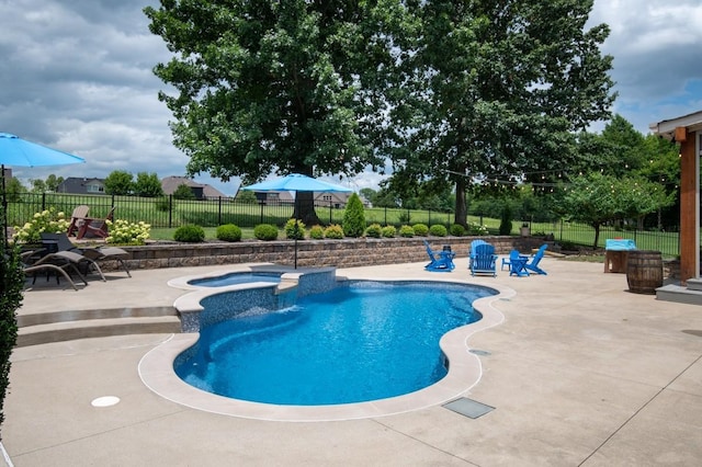 view of swimming pool with a patio area, a fenced backyard, and a pool with connected hot tub