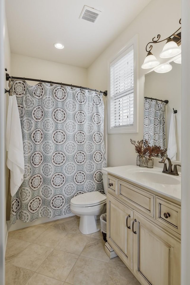 bathroom featuring tile patterned flooring, visible vents, vanity, and toilet