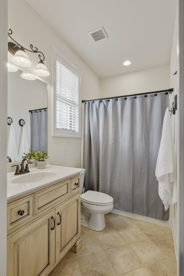 full bathroom featuring toilet, tile patterned flooring, visible vents, and vanity