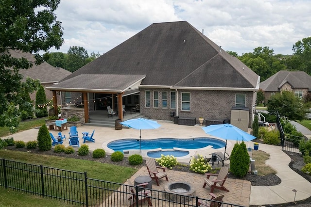 view of swimming pool featuring a patio, an in ground hot tub, and a fire pit