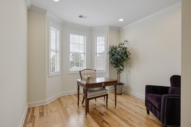 office space featuring light wood-style flooring, visible vents, ornamental molding, and baseboards