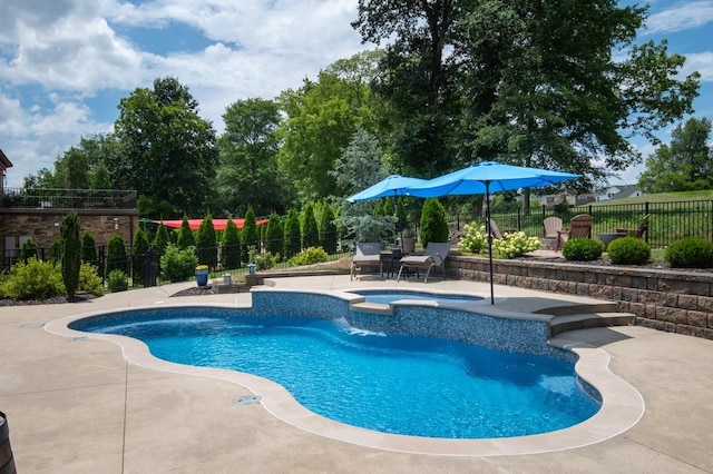 view of pool with an in ground hot tub and a patio area