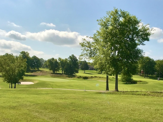 view of property's community with a yard and golf course view