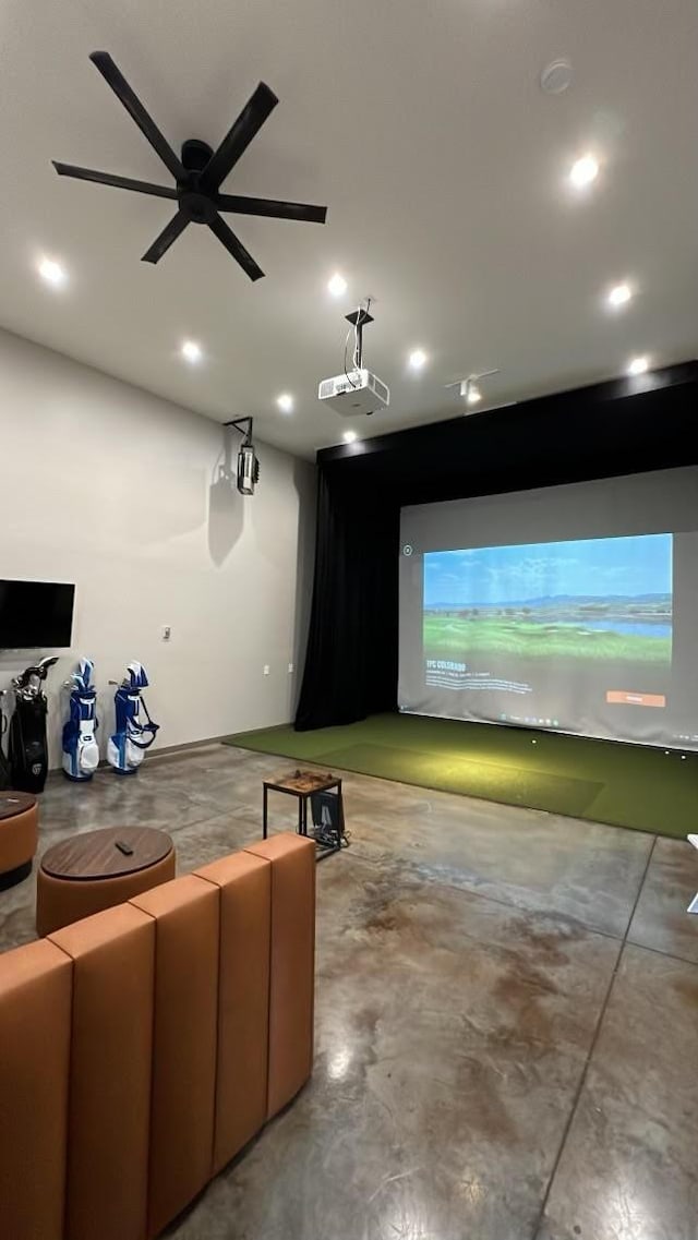 home theater room featuring golf simulator, recessed lighting, and concrete flooring