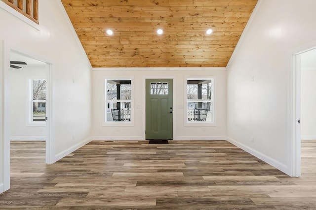 foyer with high vaulted ceiling, baseboards, and wood finished floors