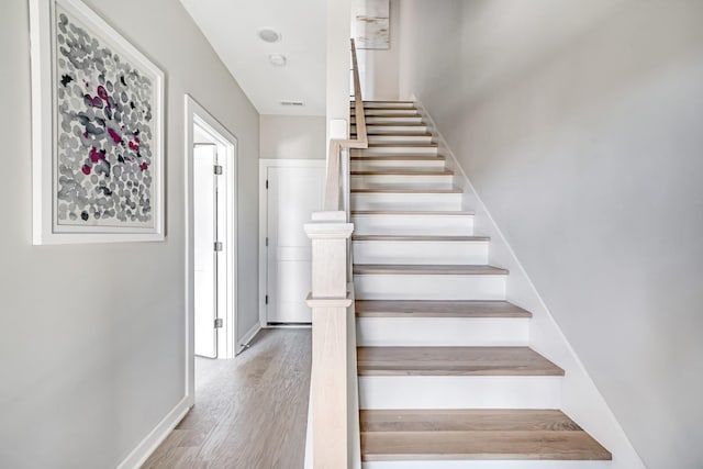 stairway featuring hardwood / wood-style flooring