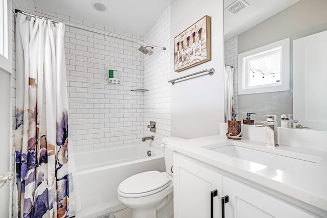 full bathroom with shower / tub combo with curtain, vanity, and toilet