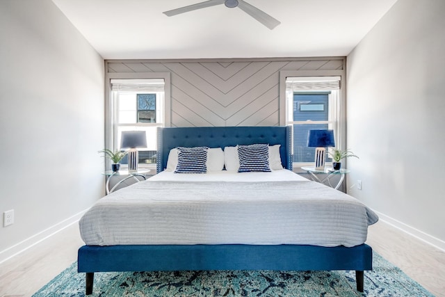 bedroom with wooden walls and ceiling fan