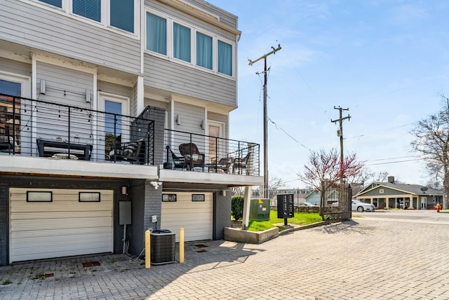 view of front of house with central AC and a garage