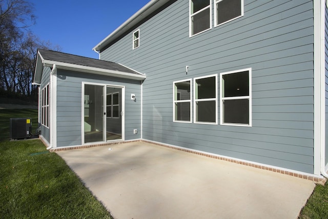 back of property featuring a patio, a yard, and central AC unit