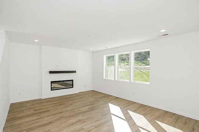 unfurnished living room featuring light wood-type flooring