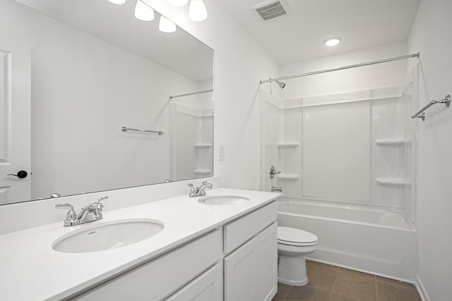 full bathroom with tile patterned flooring, vanity, washtub / shower combination, and toilet