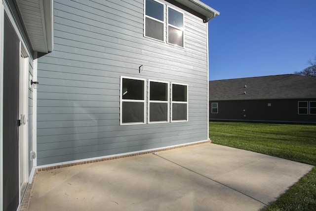 rear view of house with a yard and a patio area