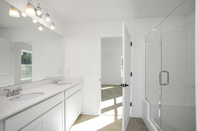 bathroom featuring an enclosed shower, vanity, and tile patterned floors