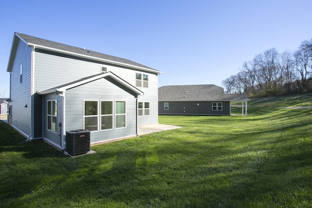 back of house featuring central AC and a lawn