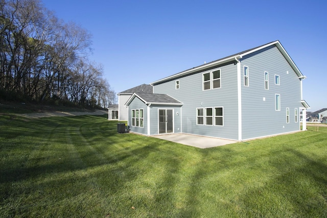 rear view of house featuring a yard, a patio, and central air condition unit