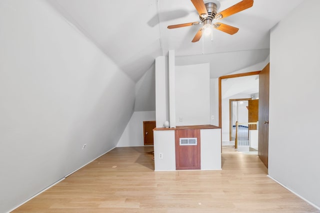 additional living space featuring ceiling fan, lofted ceiling, and light hardwood / wood-style flooring