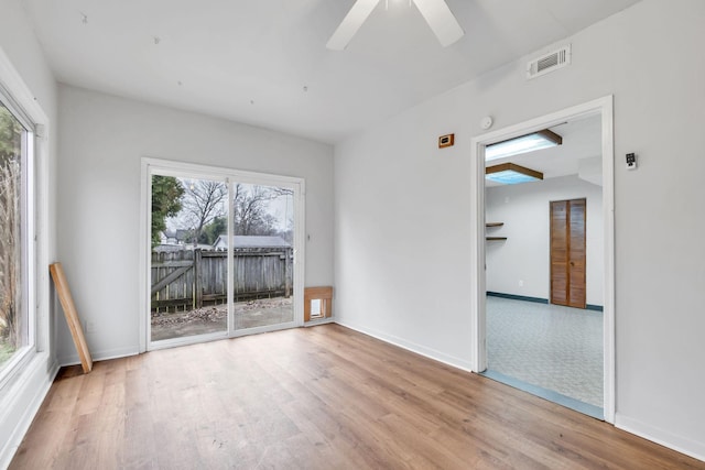 empty room with ceiling fan and light wood-type flooring