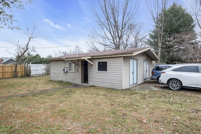 back of property featuring cooling unit and a lawn