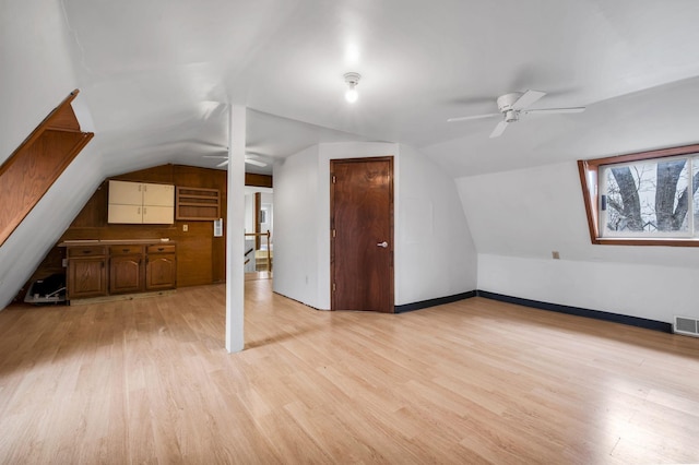 additional living space featuring vaulted ceiling, ceiling fan, and light hardwood / wood-style flooring