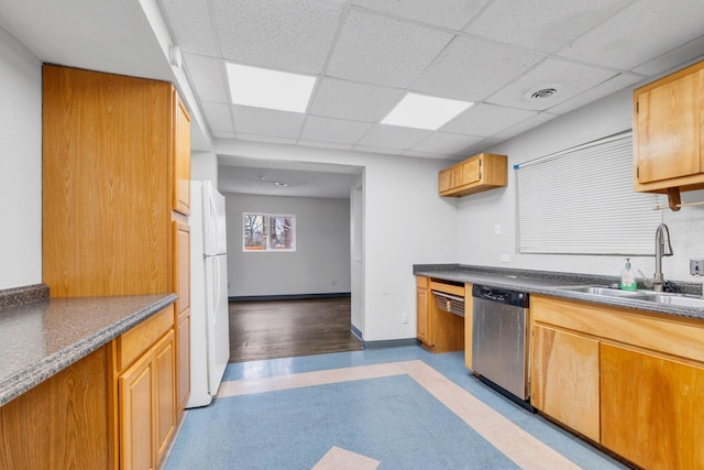 kitchen featuring a drop ceiling, sink, stainless steel dishwasher, and white fridge