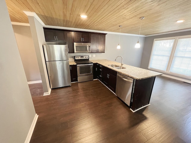 kitchen featuring appliances with stainless steel finishes, pendant lighting, sink, ornamental molding, and light stone countertops