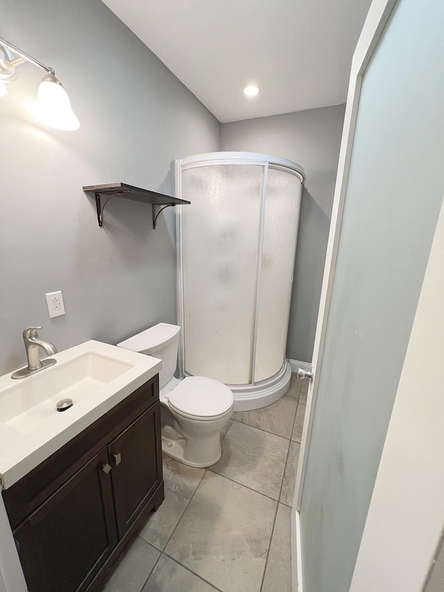 bathroom featuring an enclosed shower, vanity, and toilet