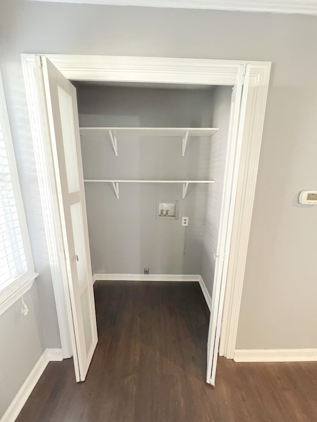 clothes washing area featuring dark hardwood / wood-style flooring and hookup for a washing machine