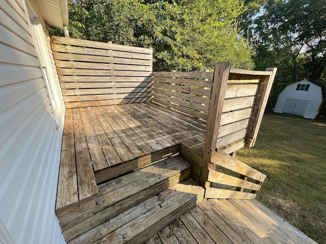 deck with a yard and a storage shed