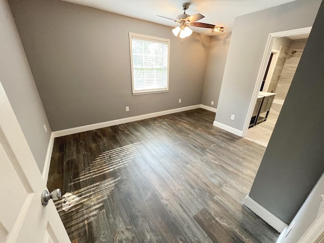 unfurnished room with dark hardwood / wood-style flooring and ceiling fan