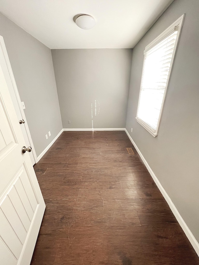 empty room with dark hardwood / wood-style floors