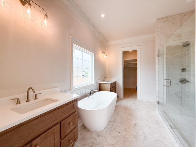 full bath featuring ornamental molding, a stall shower, a sink, and a walk in closet