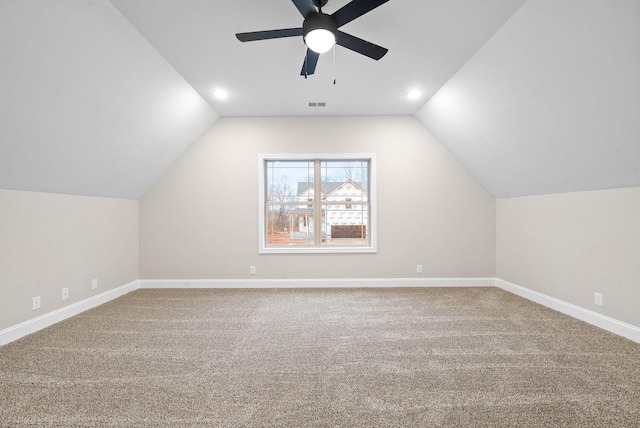 bonus room with vaulted ceiling, carpet flooring, and ceiling fan