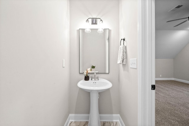 bathroom featuring ceiling fan and vaulted ceiling