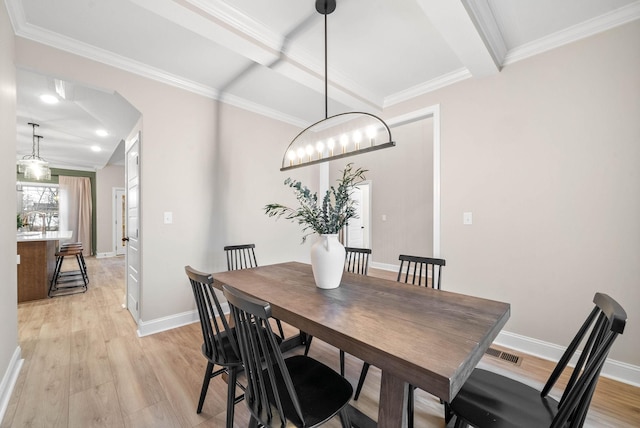 dining room with beam ceiling, light hardwood / wood-style flooring, and ornamental molding