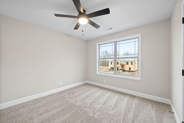 spare room featuring ceiling fan and carpet flooring