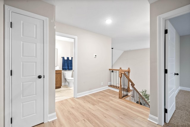 corridor with light hardwood / wood-style flooring