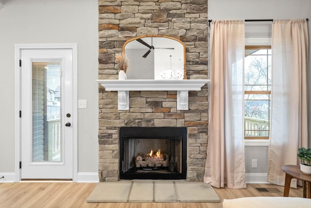 room details featuring a fireplace and wood-type flooring