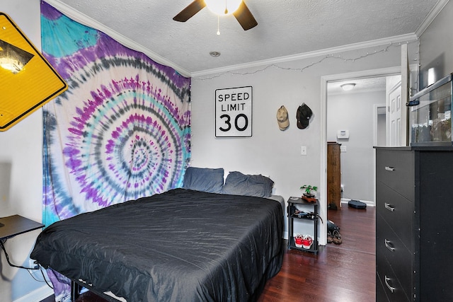 bedroom with ceiling fan, ornamental molding, dark hardwood / wood-style floors, and a textured ceiling