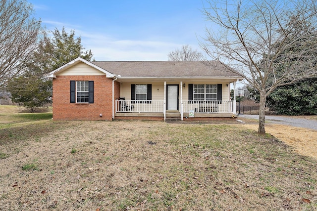 ranch-style home featuring a porch and a front lawn