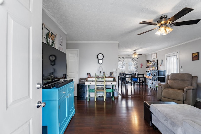 living room featuring crown molding, ceiling fan, dark hardwood / wood-style floors, and a textured ceiling